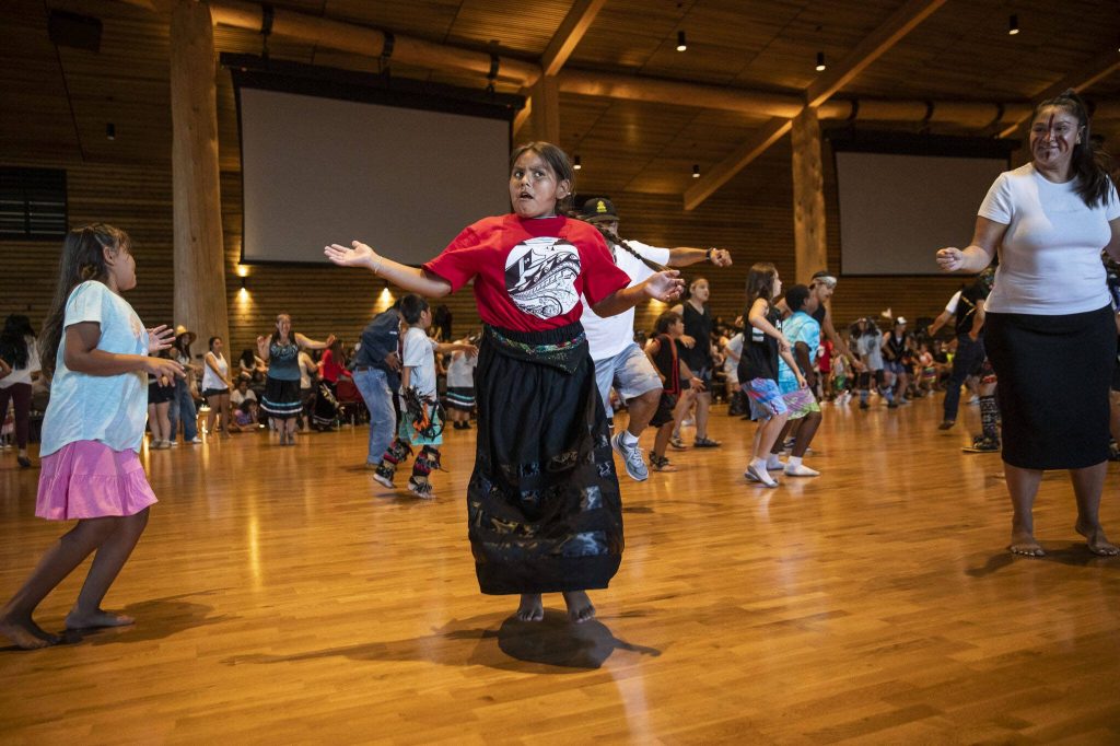 A young girl dances in regalia with her Canoe Family and other tribal members at the Tulalip Gathering Hall on Thursday, July 27, 2023 in Tulalip, Washington. (Olivia Vanni / The Herald)