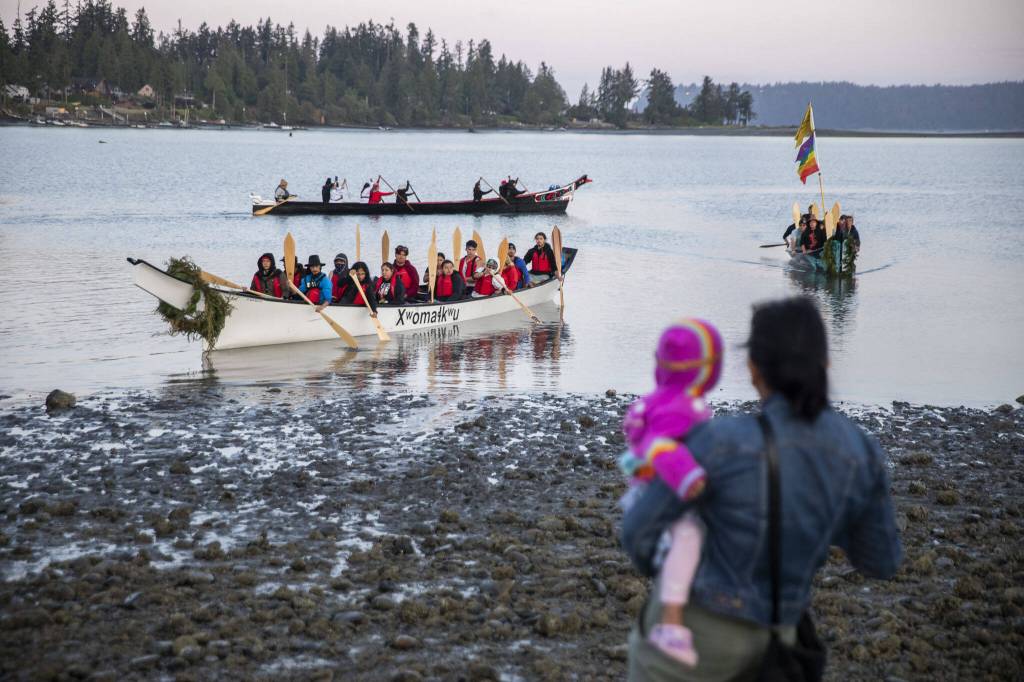 People watch from the shore as different Canoe Families set off from Tulalip for the next leg of the journey on Friday, July 28, 2023. (Olivia Vanni / The Herald)
