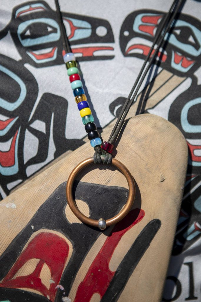 Doug Chilton, 58, of the Tlingit tribe, wears a necklace during the 2023 Washington Tribes Canoe Journey in Bellingham, Washington on Sunday, July 23, 2023. His necklace represents how many trips he has been on and honors the canoe builders. (Annie Barker / The Herald)