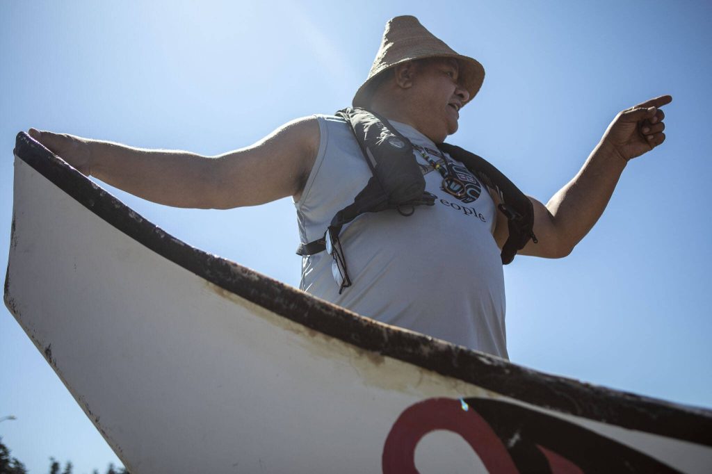 Doug Chilton, 58, of the Tlingit tribe, points to their future destination during the 2023 Washington Tribes Canoe Journey in Bellingham, Washington on Sunday, July 23, 2023. (Annie Barker / The Herald)