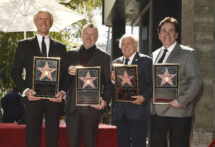 Tony Butala, second from right, a founding member of pop vocal group The Lettermen, poses with current group members, from left, Donovan Tea, Rob Gulack and Bobby Poynton after The Lettermen received a star on the Hollywood Walk of Fame, Monday, Feb. 24, 2020, in Los Angeles. (AP Photo/Chris Pizzello)