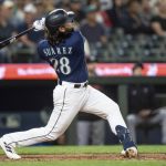 Seattle Mariners' Eugenio Suarez hits a two-run home run off Minnesota Twins relief pitcher Oliver Ortega during the seventh inning of a baseball game, Monday, July 17, 2023, in Seattle. (AP Photo/Stephen Brashear)