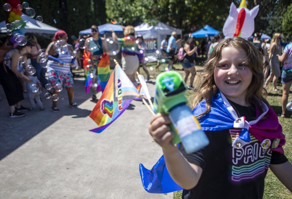 A child blows bubbles during the second annual Arlington Pride at Legion Memorial Park in Arlington, Washington on Saturday, July 22, 2023. (Annie Barker / The Herald)
