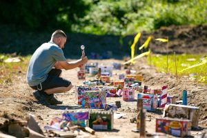 Andrei Pocol, of Seattle, lights off a rocket he bought at Boom City on July 1, 2023, in Tulalip, Washington. (Ryan Berry / The Herald)