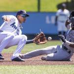 AquaSox second baseman Axel Sanchez tags out Tri-Citys DShawn Knowles during the game on Wednesday in Everett. (Olivia Vanni / The Herald)