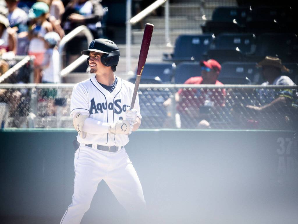 AquaSox Cole Young smiles as he steps up to bat during the game against the Tri-City Dust Devils on Wednesday, July 19, 2023 in Everett, Washington. (Olivia Vanni / The Herald)