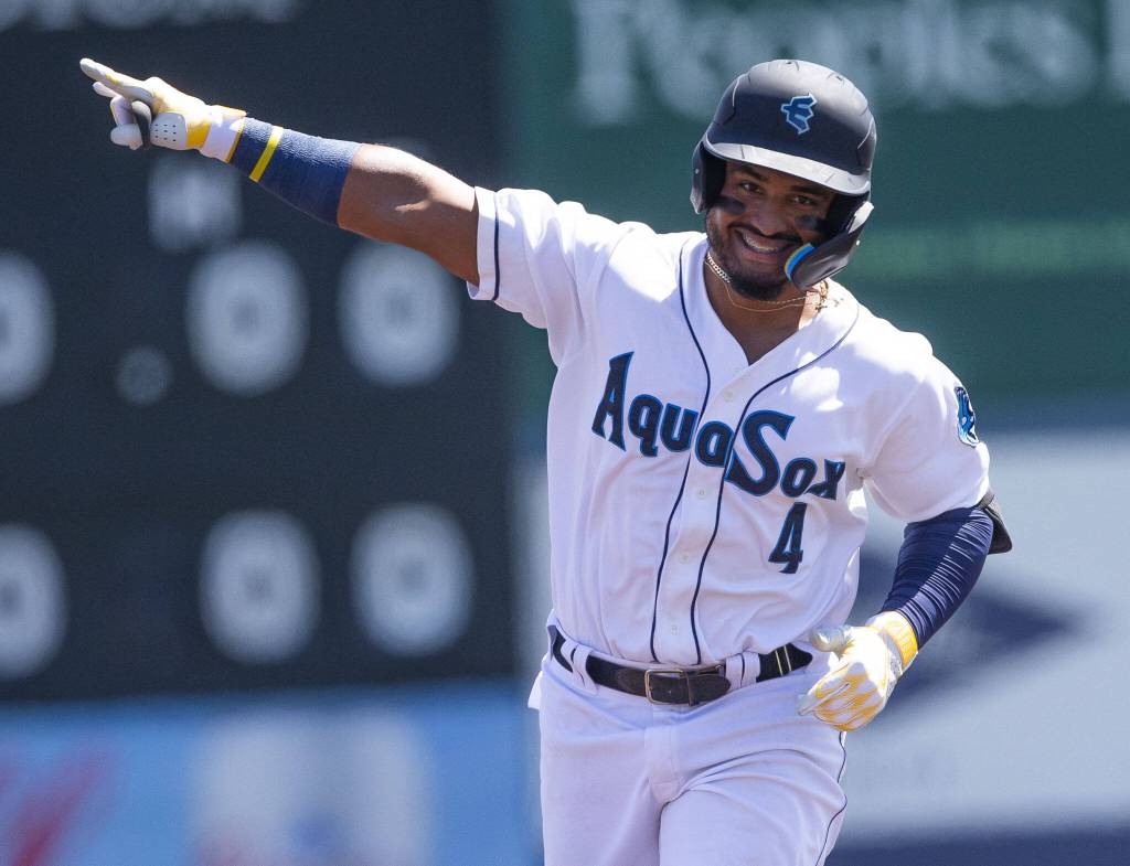 AquaSoxs Gabriel Gonzalez points to the outfield and smiles after hitting a home run during the game against the Tri-City Dust Devils on Wednesday, July 19, 2023 in Everett, Washington. (Olivia Vanni / The Herald)