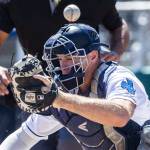A wild pitch flies over the head of AquaSox catcher Andrew Miller during the game against the Tri-City Dust Devils on Wednesday, July 19, 2023 in Everett, Washington. (Olivia Vanni / The Herald)