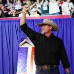 Pinal County sheriff Mark Lamb waves to a cheering crowd at a Save America Rally Friday, July 22, 2022, in Prescott, Ariz. Lamb has filed federal paperwork to run for the U.S. Senate in Arizona, Monday, April 10, 2023, becoming the first Republican to jump into a high-profile race for the seat now held by independent Sen. Kyrsten Sinema. (AP Photo/Ross D. Franklin)