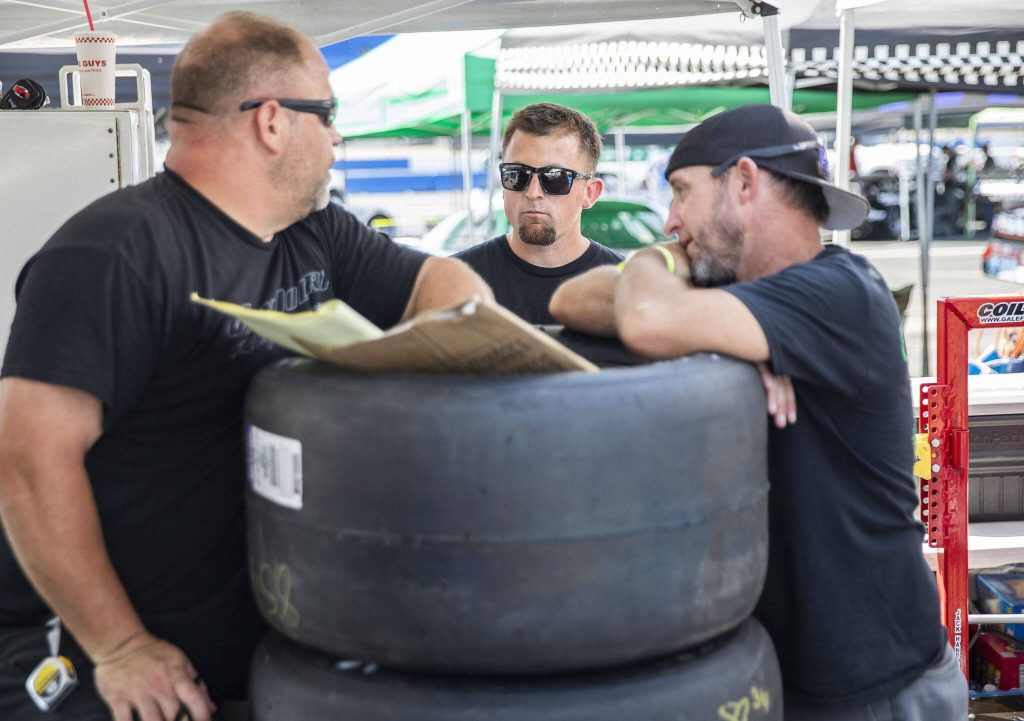Tayler Riddle, center, talks with his pit crew during practice for Summer Showdown at Evergreen Speedway on Thursday in Monroe.. (Olivia Vanni / The Herald)