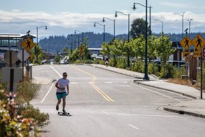 A longboarder rides down the newly opened First Street on Wednesday, July 26, 2023 in Mukilteo, Washington. (Olivia Vanni / The Herald)