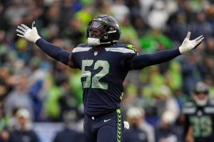 Seattle Seahawks defensive end Darrell Taylor (52) celebrates after his sack of Los Angeles Rams quarterback Baker Mayfield during the second half of an NFL football game Sunday, Jan. 8, 2023, in Seattle. (AP Photo/Abbie Parr)