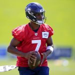 Seahawks quarterback Geno Smith gets set to pass during the first day of training camp on Thursday in Renton. (AP Photo/Lindsey Wasson)
