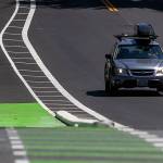 A car drives west on Madison Street past new bike lane curbs on Thursday, July 27, 2023 in Everett, Washington. (Olivia Vanni / The Herald)