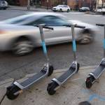 Bird scooters are lined up along the intersection of Colby Avenue and Hewitt Avenue in downtown Everett in November, one solution to reducing the abundance of cars on city streets. (Olivia Vanni / The Herald file photo)