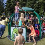 Children play together on a moving structure during the Nubian Jam at Forest Park in Everett, Washington on Saturday, July 29, 2023. (Annie Barker / The Herald)