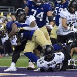 Washington running back Cameron Davis scores a touchdown during the first half of a game against Colorado on Nov. 19, 2022, in Seattle. (AP Photo/Stephen Brashear)
