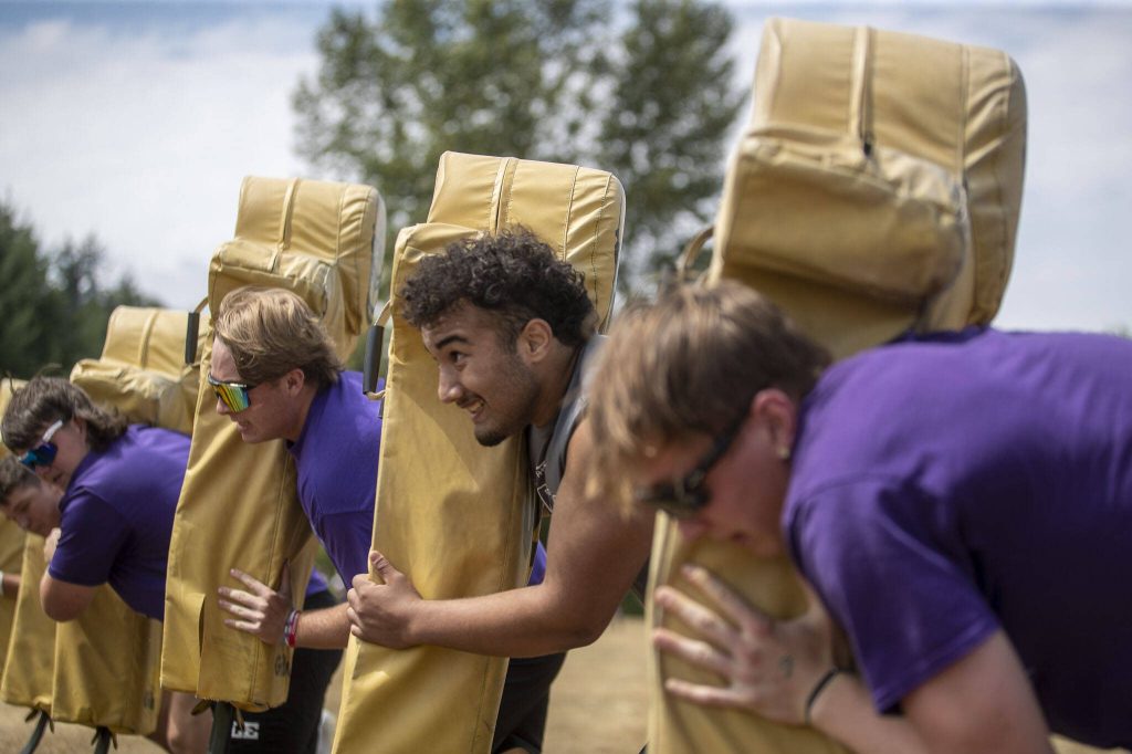 Lake Stevens players participate in the 6-man sled drive during the Lakewood 7on7 passing tournament and lineman challenge at Lakewood High School in Arlington, Washington on Saturday, July 29, 2023. (Annie Barker / The Herald)