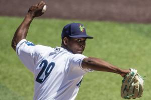 AquaSox’s Raul Alcantara winds up to pitch during the game against the Tri-City Dust Devils on Wednesday, July 19, 2023 in Everett, Washington. (Olivia Vanni / The Herald)