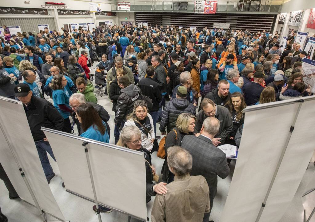 Hundreds of Alderwood Community Church and Mill Creek Foursquare Church leaders and members fill Cascade High Schools lunchroom during Sound Transits in-person open house on Wednesday, Feb. 15, 2023 in Everett, Washington. (Olivia Vanni / The Herald)