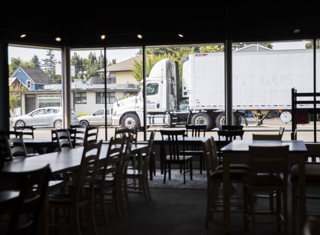 A semi-truck waits to deliver more furniture on Thursday, Aug. 24, 2023 in Everett, Washington. (Olivia Vanni / The Herald)