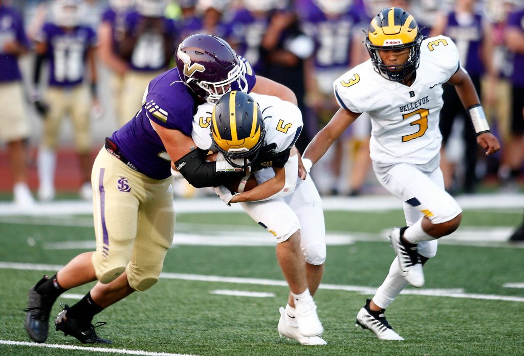 Lake Stevens Bryce Slezak takes down the ball carrier for a tackle for loss against Bellevue Sept. 9, 2022, at Lake Stevens High School. (Ryan Berry / The Herald)