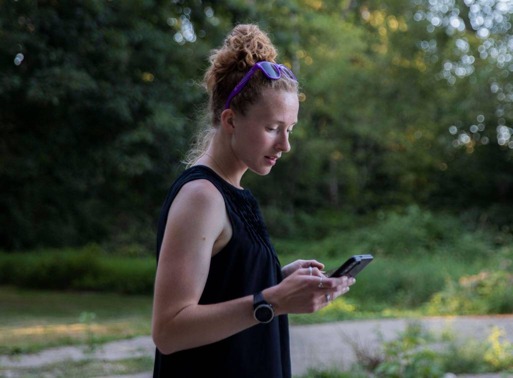Jessi Beyer checks her work phone before heading out to Sultan on Wednesday, Aug. 2, 2023 in Monroe, Washington. (Olivia Vanni / The Herald)