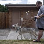 Marc Boucher walks his wife Amandas service dog Loki. Amanda Boucher has health problems that leave her disabled. (Annie Barker / The Herald)