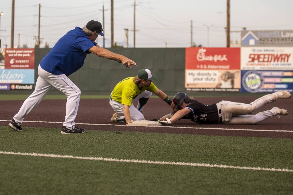 Everett Merchants manager Harold Pyatte gives directions to a player during a game on Friday at Funko Field in Everett. (Annie Barker / The Herald)