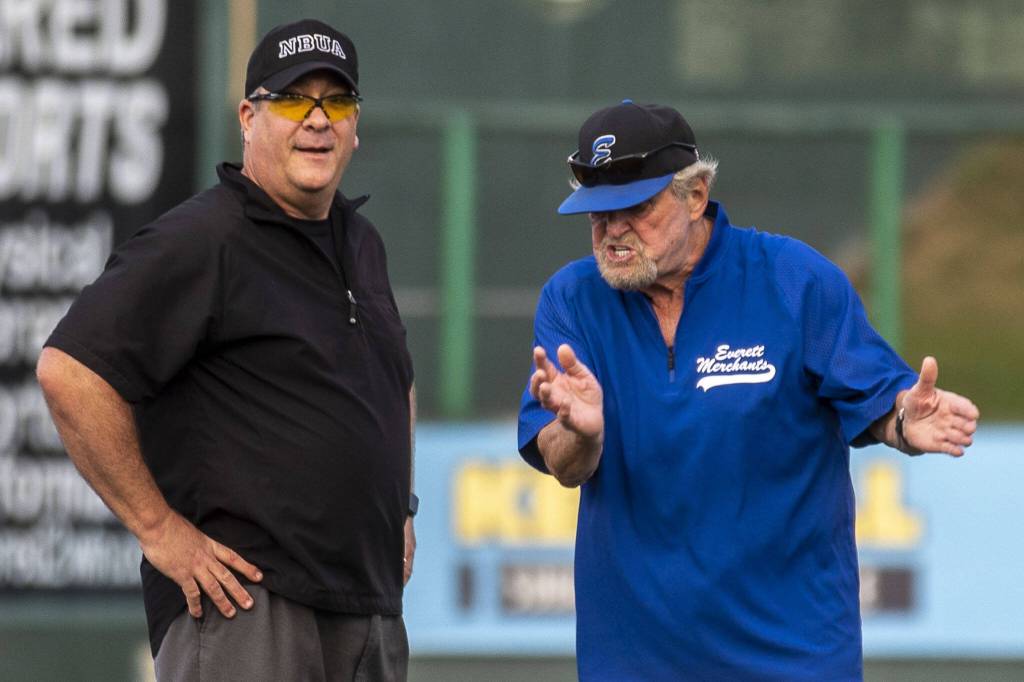 Everett Merchants manager Harold Pyatte (right) argues with an umpire during a game on Friday at Funko Field in Everett. (Annie Barker / The Herald)