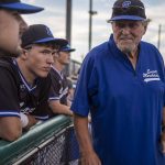 Everett Merchants manager Harold Pyatte (right) talks with players during his final game on Friday at Funk0 Field in Everett. (Annie Barker / The Herald)