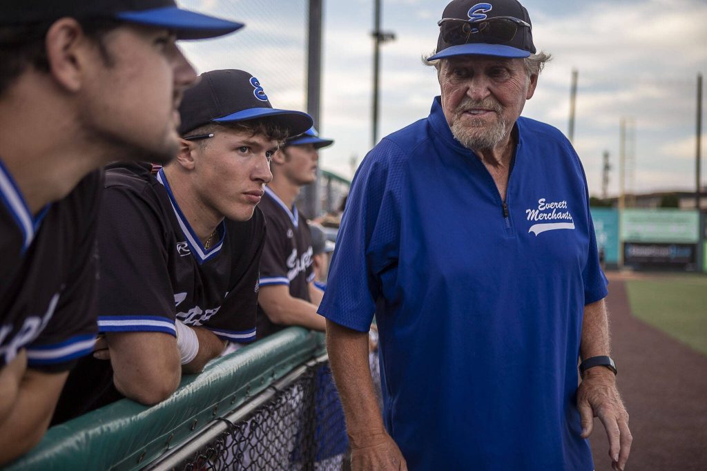Everett Merchants manager Harold Pyatte (right) talks with players during his final game on Friday at Funk0 Field in Everett. (Annie Barker / The Herald)