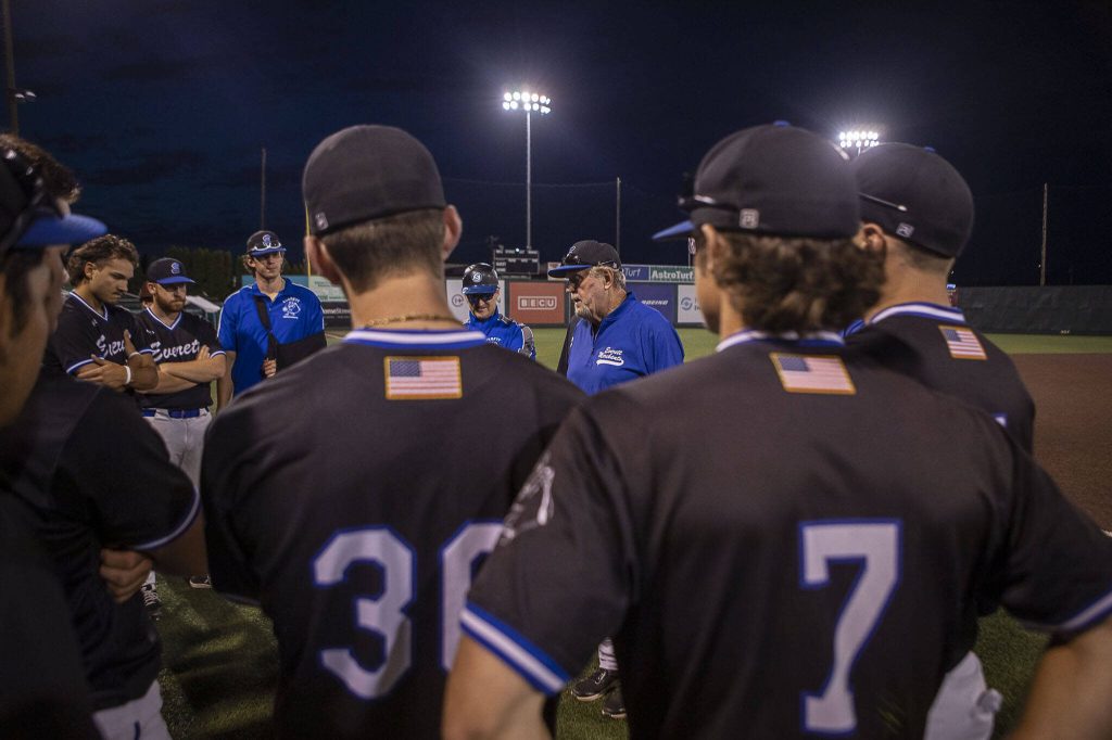 Everett Merchants manager Harold Pyatte gives his final post-game talk on Friday at Funko Field in Everett. (Annie Barker / The Herald)