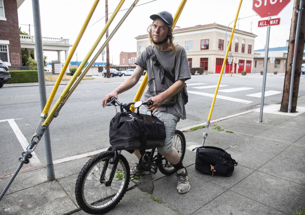 Dustin De Marcey rides his bike down Oakes Avenue on Tuesday, Aug. 8, 2023 in Everett, Washington. (Olivia Vanni / The Herald)