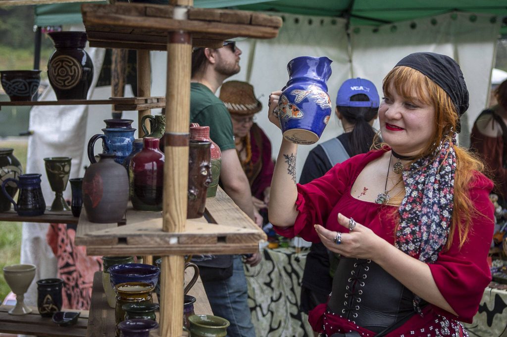 Attendees wander booths during the Washington Midsummer Renaissance Faire at Sky Meadows Park in Snohomish, Washington on Sunday, Aug. 6, 2023. (Annie Barker / The Herald)