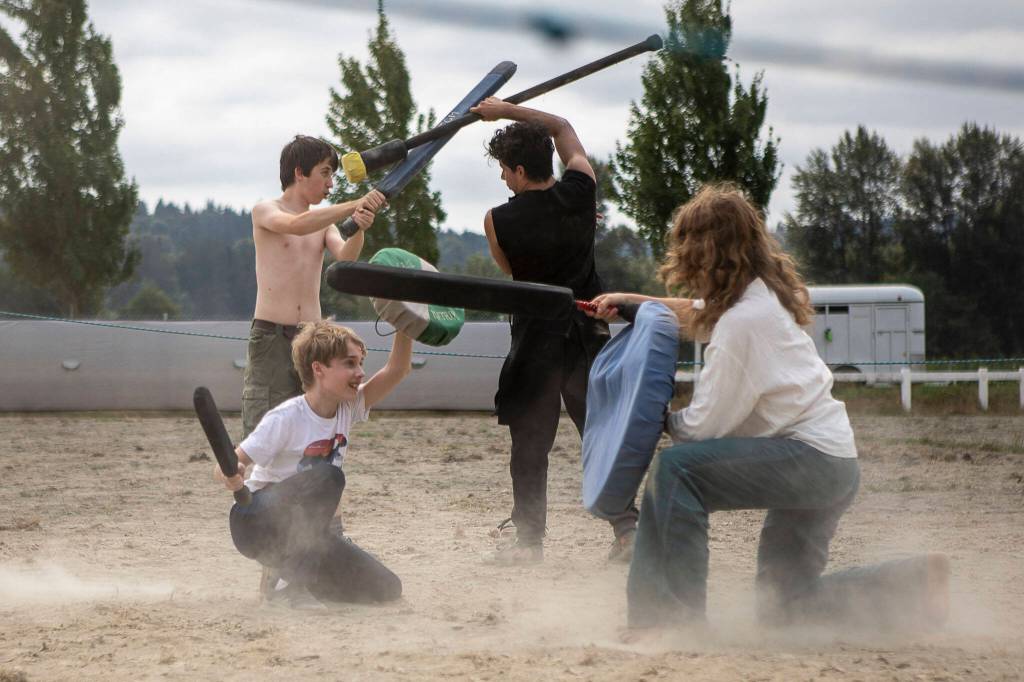 Kids feign battle during the Washington Midsummer Renaissance Faire at Sky Meadows Park in Snohomish, Washington, on Sunday, Aug. 6, 2023. (Annie Barker / The Herald)