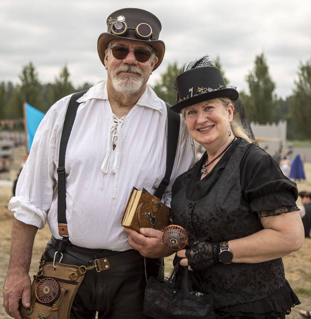 Mount Vernon residents Miles Baron, 64, left, and Lisa Case, 57, right, pose for a photo during the Washington Midsummer Renaissance Faire at Sky Meadows Park in Snohomish, Washington on Sunday, Aug. 6, 2023. (Annie Barker / The Herald)