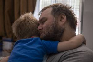 Marc Boucher holds his son Maverick, 4, at a motel on Thursday, Aug. 10, 2023. (Annie Barker / The Herald)