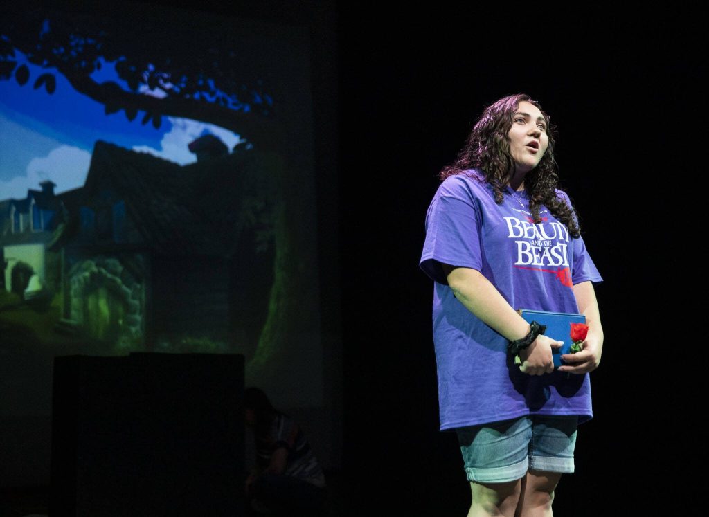 Avryn Flores, who played the role of Belle, performs a solo song during a dress rehearsal for Hope Theatres rendition of Beauty and the Beast Jr. on Friday, Aug. 4, 2023, at the Snohomish County PUDs theater in Everett, Washington. (Olivia Vanni / The Herald)