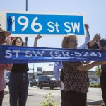 Lynnwood Mayor Christine Frizzell, second from right, and Rep. Rick Larsen, right, cut a ribbon during a ceremony to celebrate the completion of the 196th Street SW Improvement Project near the 196th and 44th Ave West intersection in Lynnwood, Washington on Tuesday, Aug. 15, 2023. (Annie Barker / The Herald)