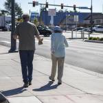 People walk near the 196th and 44th Ave West intersection in Lynnwood, Washington on Tuesday, Aug. 15, 2023. (Annie Barker / The Herald)