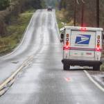 A mail carrier delivers mail along Dubuque Road in Snohomish on Wednesday, Jan. 12, 2022. (Olivia Vanni / The Herald)