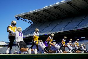 Members of the Washington defense, including defensive ends Zion Tupuola-Fetui, left, and Bralen Trice (8), line up for drills during the NCAA college football team's practice Wednesday, Aug. 2, 2023, in Seattle. (AP Photo/Lindsey Wasson)