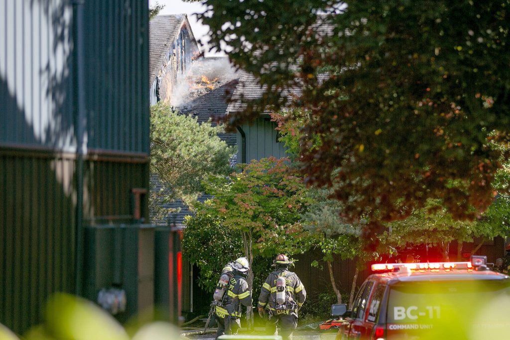 Emergency responders work the scene of an apartment fire at the Park 120 apartment complex on Casino Road on Friday, August 11, 2023, in Everett, Washington. (Ryan Berry / The Herald)