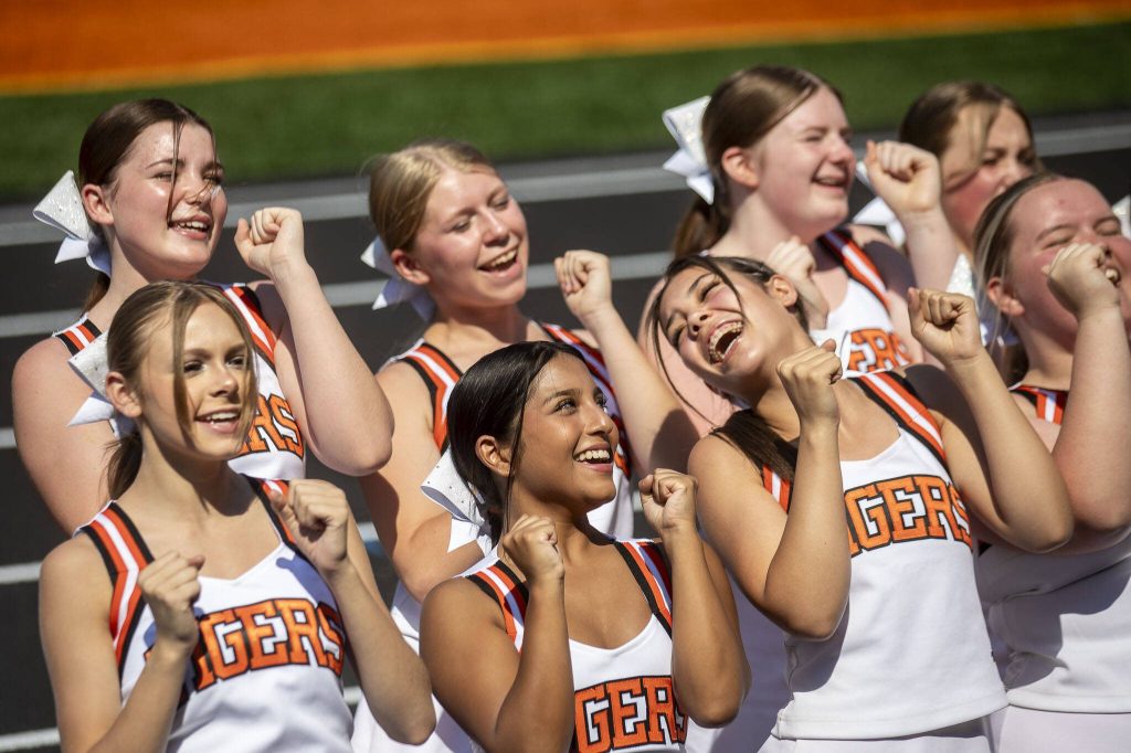 Granite Falls cheerleaders perform during a soft opening for the new track and field Monday at Granite Falls High School. (Annie Barker / The Herald)