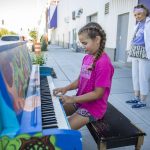 Kenzie Norton, 10, plays a part of the song Baby Bumblebee on piano painted by Amber Forrest in front of the Imagine Childrens Museum on Wednesday, Aug. 16, 2023 in Everett, Washington. (Olivia Vanni / The Herald)