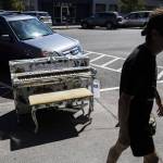 A man walks by the Produce Sounds piano by Elizabeth Person on display in front of the Sno-Isle Food Co-op on Wednesday, Aug. 16, 2023 in Everett, Washington. (Olivia Vanni / The Herald)