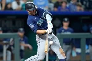 Seattle Mariners' Ty France hits a two-run single during the 10th inning of a baseball game against the Kansas City Royals Tuesday, Aug. 15, 2023, in Kansas City, Mo. The Mariners won 10-8 in 10 innings. (AP Photo/Charlie Riedel)