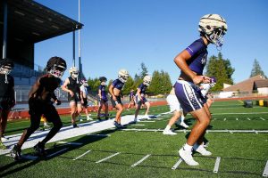 Lake Stevens players run through conditioning drills during the Vikings’ first practice of the year Wednesday, August 16, 2023, in Lake Stevens, Washington. (Ryan Berry / The Herald)