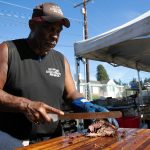 Ron Gipson of Gips Down-Home BBQ slices up some brisket during Taste Edmonds on Saturday, August 12, 2023, at Frances Anderson Play Field in Edmonds, Washington. (Ryan Berry / The Herald)